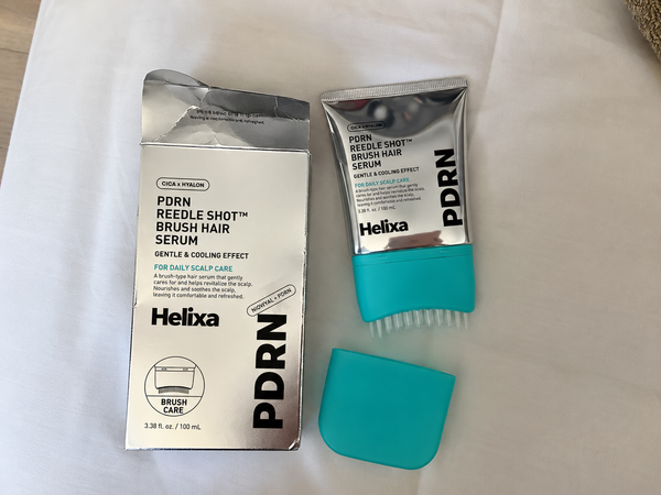 Customer holding Helixa scalp serum
