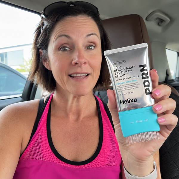 Customer holding Helixa scalp serum