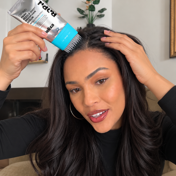 Customer holding Helixa scalp serum