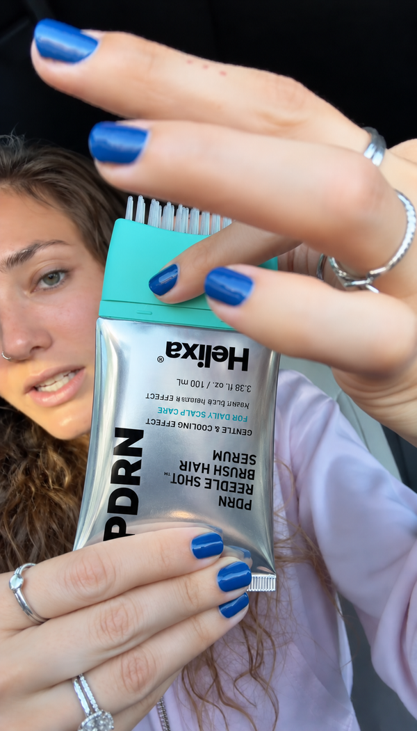 Customer holding Helixa scalp serum